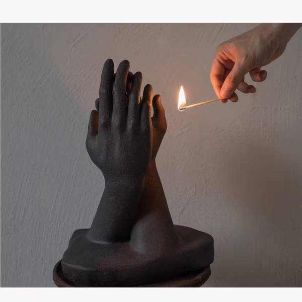 Hands Holding Candle Sculpture